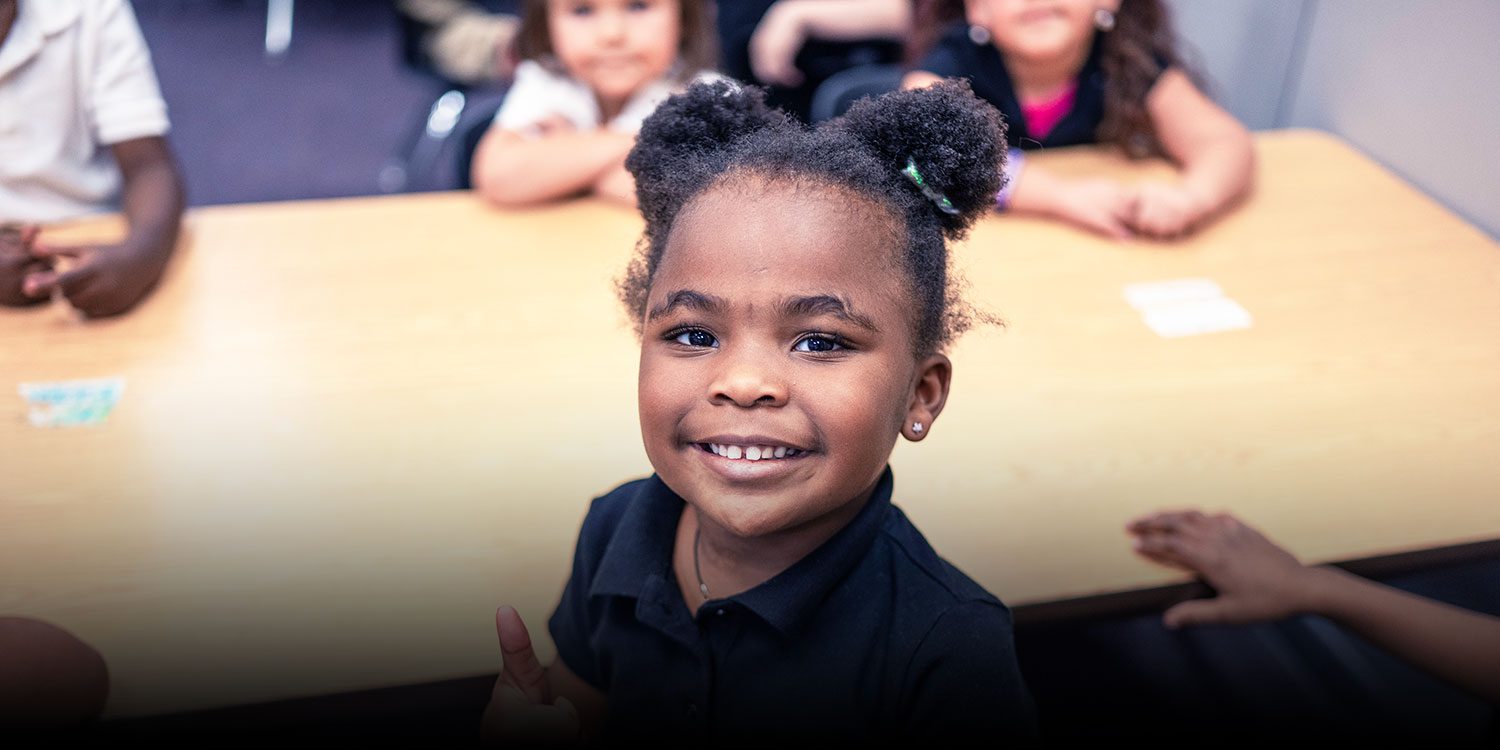 Student smiling in a classroom